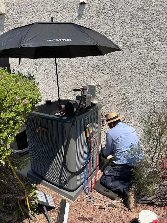 HVAC technician performing outdoor AC maintenance in Diamond Springs